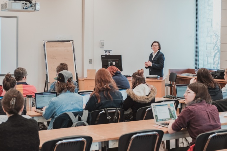 Professor speaking in front of a classroom of students