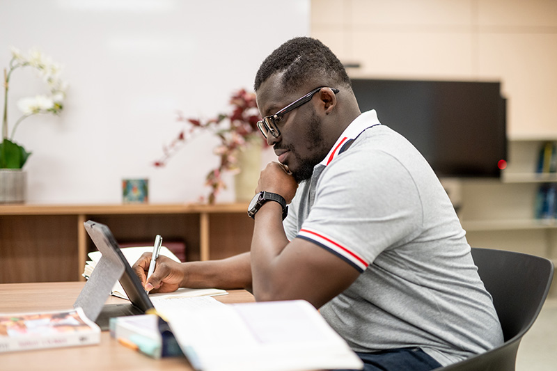 A person writing on a notebook