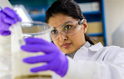 Graduate Chemical Engineering student working in lab